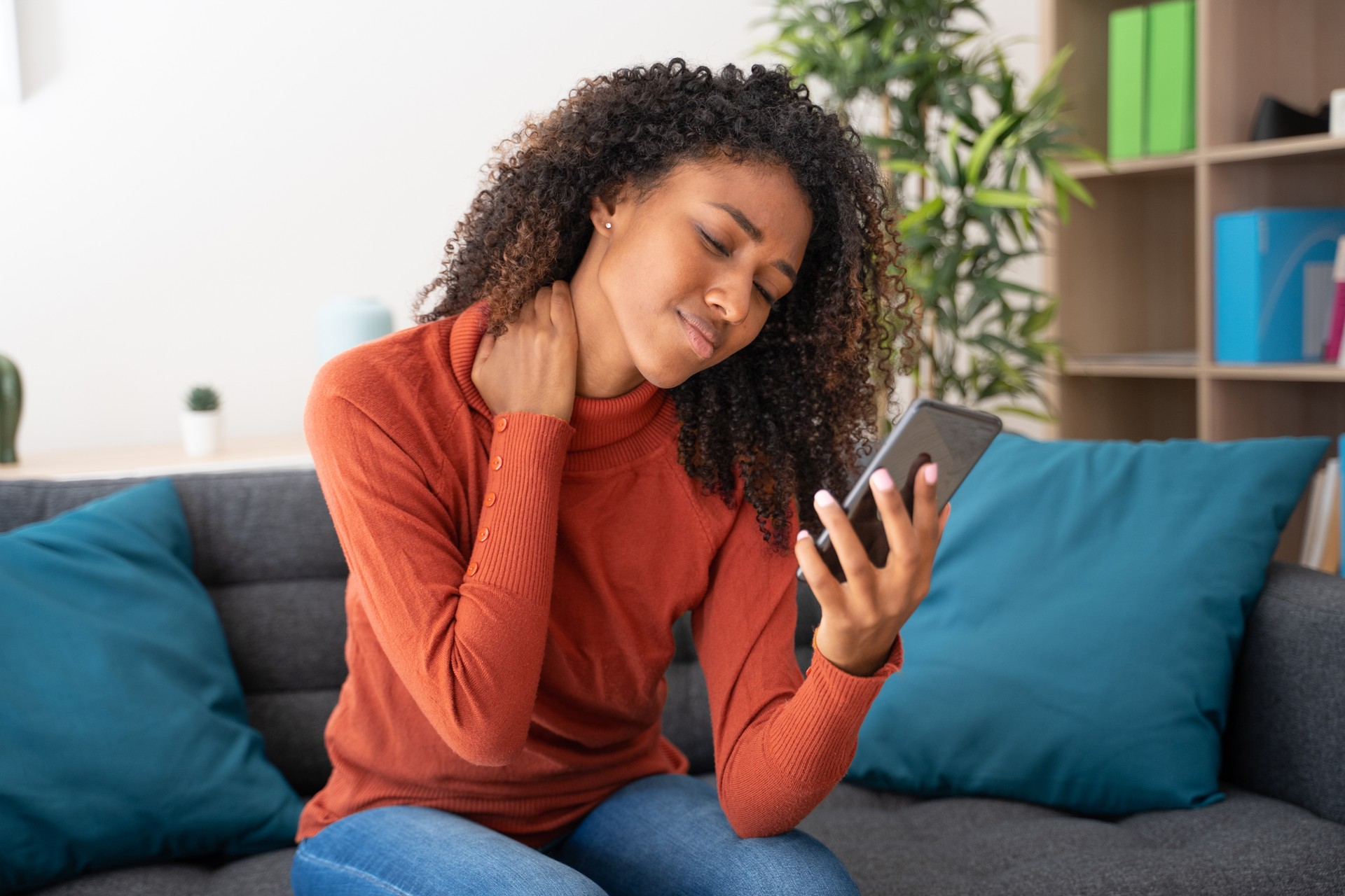 Young woman suffering from strong back ache